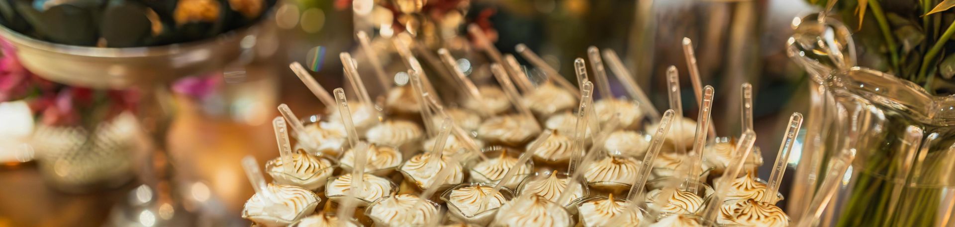 Beautifully arranged dessert table featuring a variety of sweets and flowers, perfect for events.